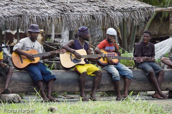 Village boys play guitar at Kopar village, Sepik River, Papua Ne Photo Fiona Harper travel writerw Guinea