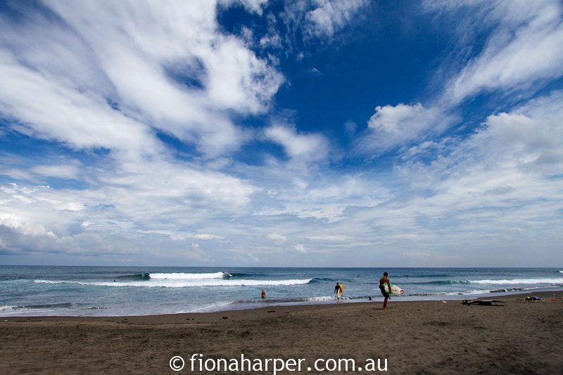 Surfers on beach, Bali, Image by Fiona Harper travel writer