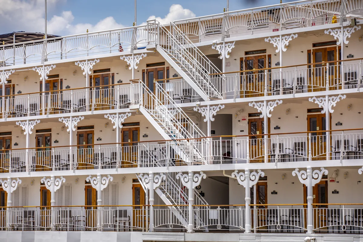 Three tiers of the American Queen's white filigree balconies, cabin doors and open staircases